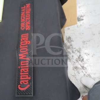 Captain Morgan bar mat with red lettering on black background, featuring "Original Spiced Rum" text. Appears in good condition.