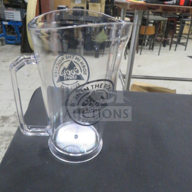 NEW 32oz Coors Light poly pitcher with handle, featuring "Born in the Rockies" logo. Brand new condition.
