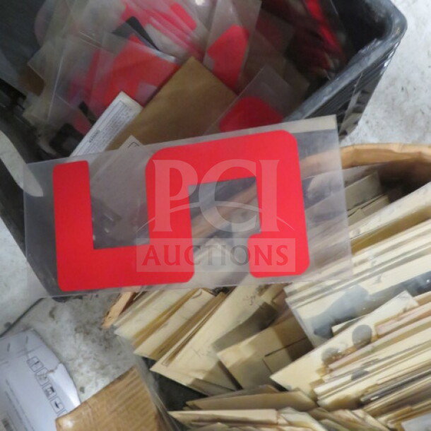 Lot of 10-inch red letters/numbers, condition appears used, stored in bins with protective sheets.