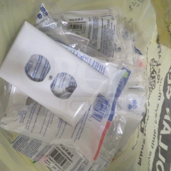Alt text: "Lot of new assorted electrical outlet plates in packaging, featuring various designs and styles."