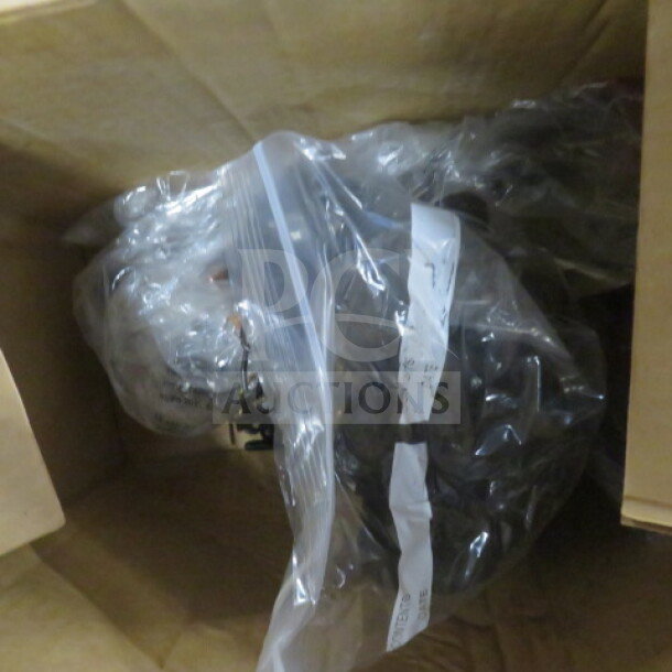 Cardboard box containing assorted miscellaneous items in clear plastic bags. Items are unorganized, condition unknown.