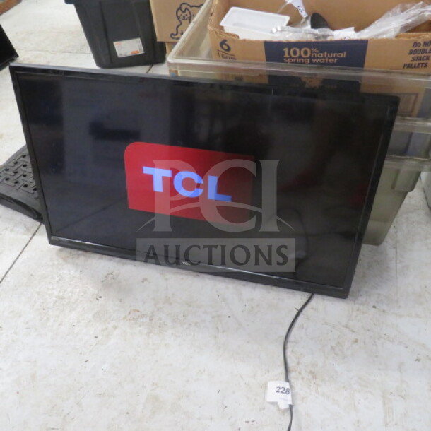 42-inch TCL flatscreen TV, model #42S, in working condition. Display shows TCL logo. Includes power cord.
