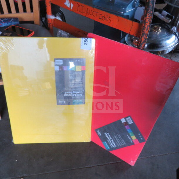 Yellow and red 24x18 cutting boards, new condition, shrink-wrapped. Tags indicate multi-color range by brand.