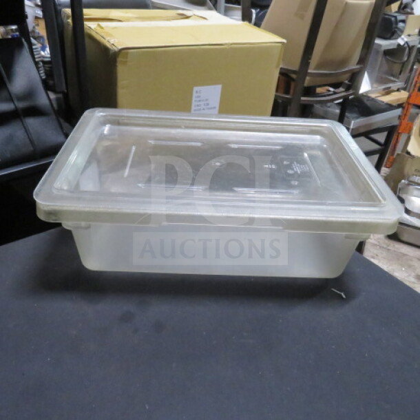 Clear 3-gallon food storage container with lid. Rectangular shape, transparent plastic, used condition, no visible markings.