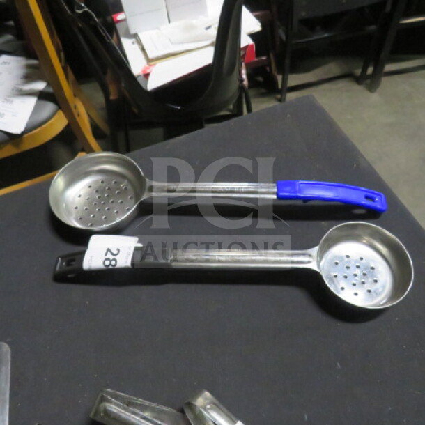 Assorted perforated spoodles, 6oz and 8oz, with colored handles. Marked with auction tag "28" indicating item lot.