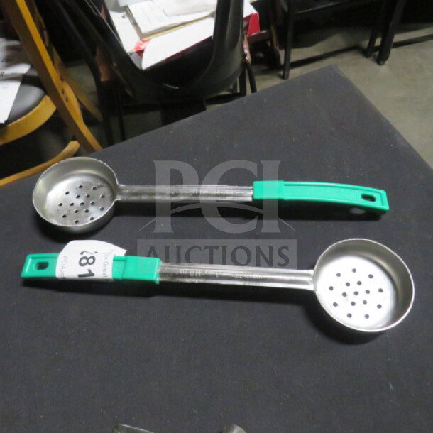 4oz perforated spoodles with green handles. Metal construction, moderate wear. Includes label "2XBID" on one handle.