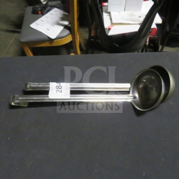 8oz stainless steel ladle, excellent condition, with long handle. Item labeled "284" for auction identification.