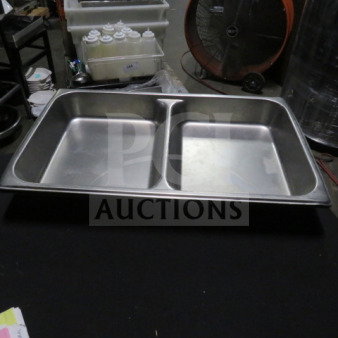 Full size 2.5-inch deep divided hotel pan in stainless steel. Features two compartments, ideal for food service use.