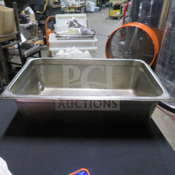 Stainless steel full size 6-inch deep hotel pan in good condition, ideal for catering or restaurant use.