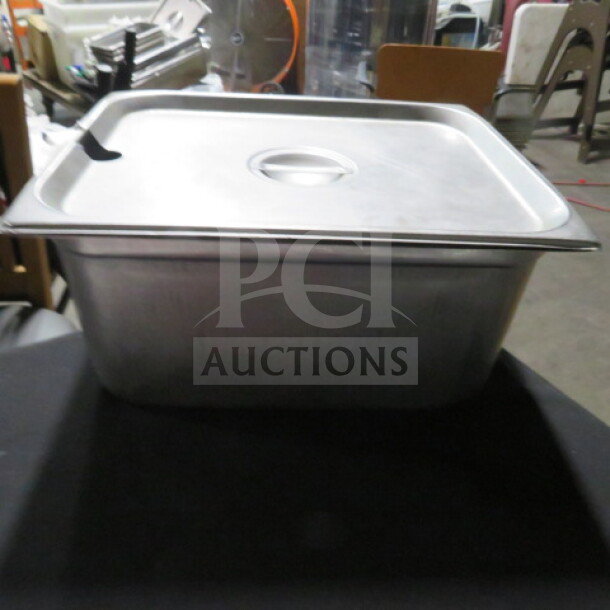 One half-size, 6-inch deep hotel pan with lid, metal, used condition, ideal for commercial kitchens.