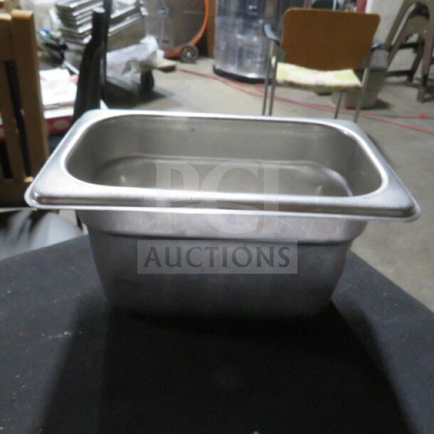 1/9 size 4-inch deep stainless steel hotel pan, used condition. Ideal for food service, durable design, model 5XBID.