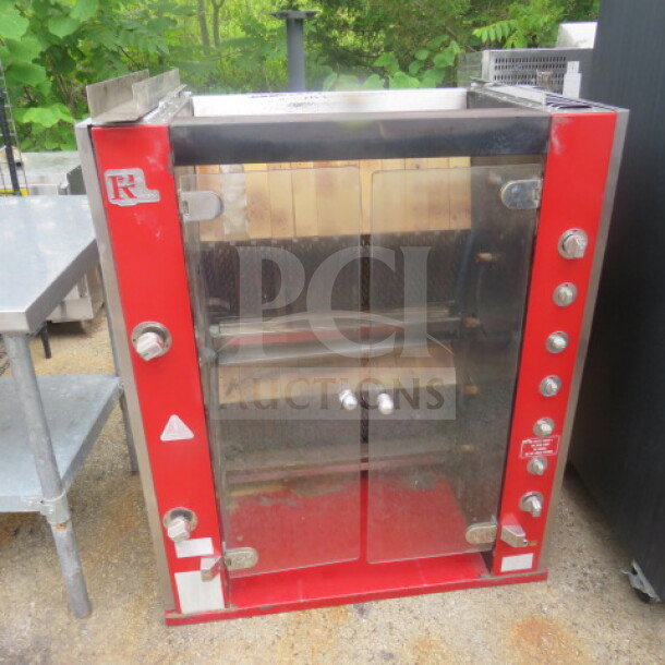 Rotisol rotisserie, 38x20x45 inches, red and stainless steel, glass doors, multiple control knobs, used condition.