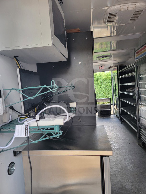 2021 SDG 8.5' x 20' mobile trailer interior, featuring POS workstation, merchandisers, and freezers. Power cables visible.