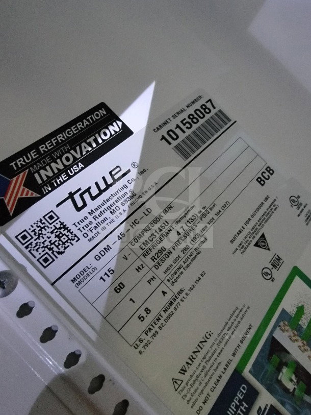 Label on True refrigeration unit, model GDM-45-HC-LD, showing serial number, compressor info, and warnings.
