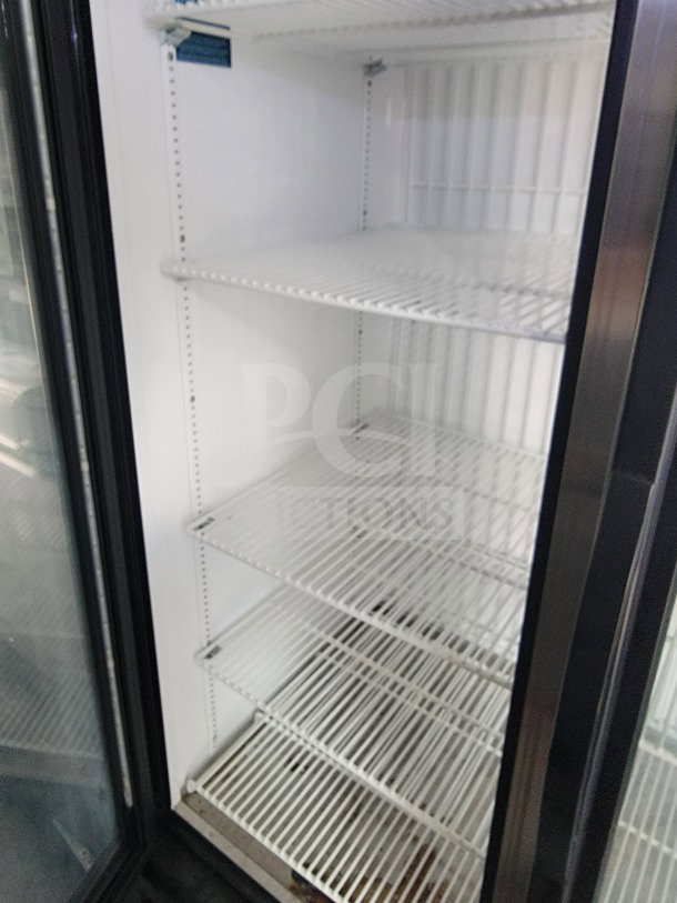 Interior view of a mobile fulfillment trailer's freezer section with white wire shelves. Appears clean and spacious.
