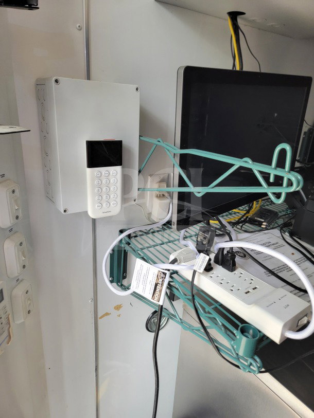 SDG 20 mobile fulfillment trailer interior with POS workstation, power strip, keypad, and wiring. Features and condition visible.