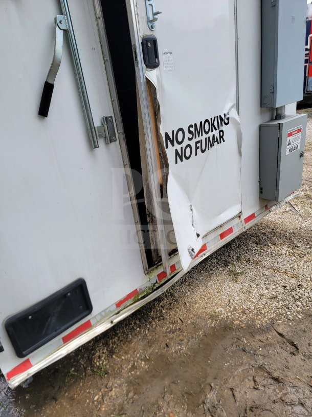 2021 Diamond Cargo 8.5' x 24' mobile kitchen trailer, damaged door, "No Smoking" text, visible wear.