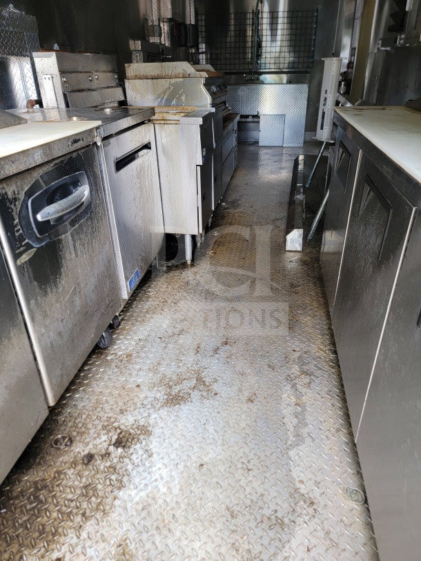 2021 Diamond Cargo 8.5' x 24' tandem-axle mobile kitchen trailer interior. Features NAKS hood, Pitco fryers, True & Turbo Air refrigeration.