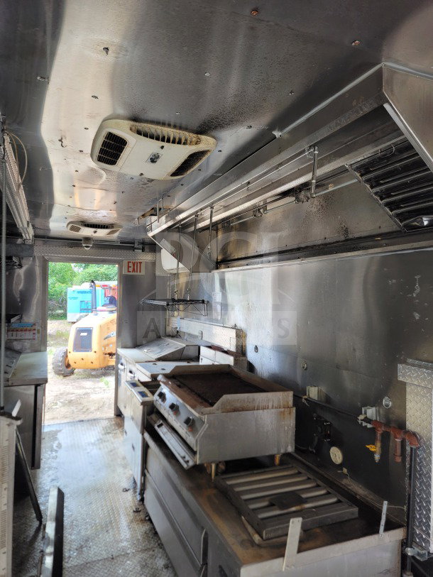 2021 Diamond Cargo 8.5' x 24' mobile kitchen trailer interior with NAKS hood and Pitco fryers. Shows cooking and refrigeration equipment, condition visible.