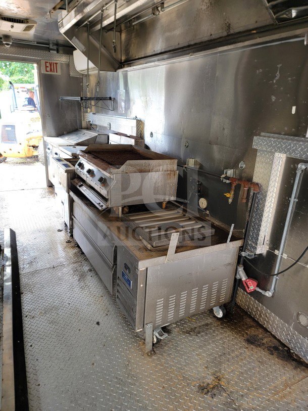 2021 Diamond Cargo 8.5' x 24' mobile kitchen trailer interior, featuring a NAKS hood, Pitco fryers, and Turbo Air refrigeration.
