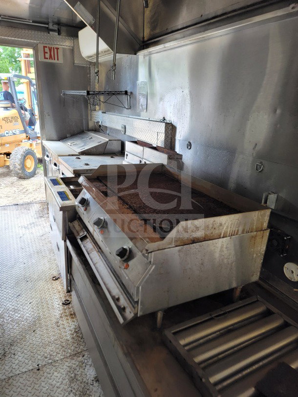 2021 Diamond Cargo 8.5' x 24' mobile kitchen trailer interior with griddle, fryers, and NAKS hood. Good condition.