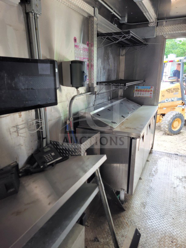 2021 Diamond Cargo 8.5' x 24' mobile kitchen trailer with stainless steel surfaces and shelving, featuring NAKS hood.
