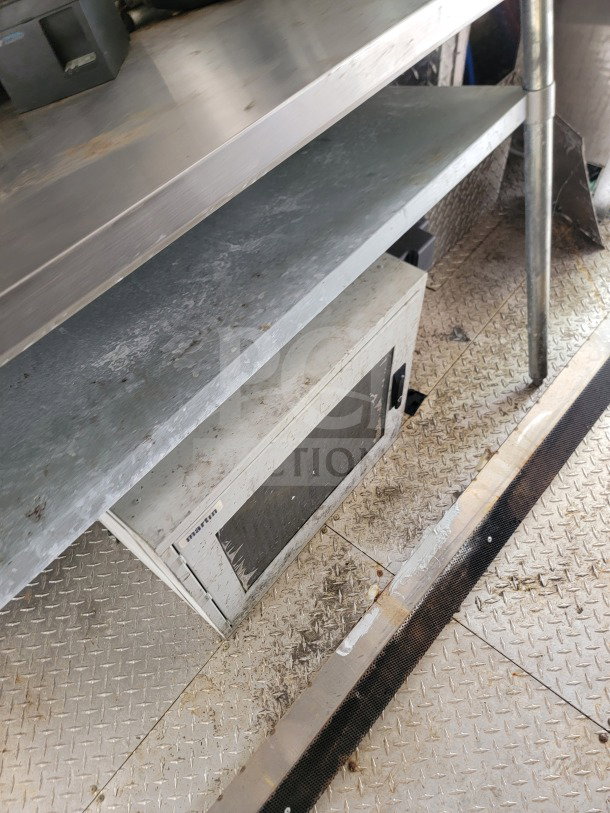 2021 Diamond Cargo 8.5' x 24' mobile kitchen trailer interior showing shelving, Marathon unit, and diamond plate flooring.