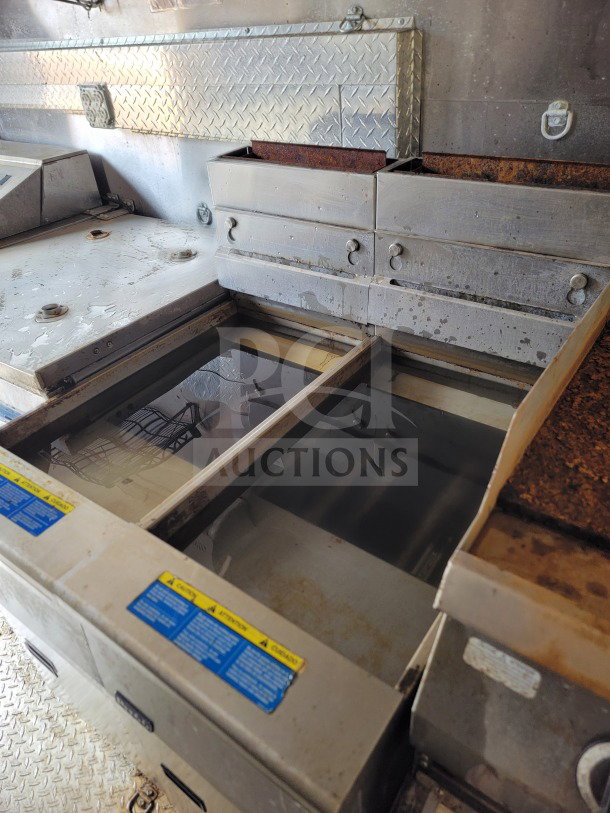 2021 Diamond Cargo mobile kitchen trailer interior, showing Pitco fryers and metal surfaces, moderate wear visible.