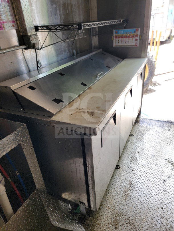 2021 Diamond Cargo 8.5' x 24' mobile kitchen trailer interior; stainless steel counter, storage below; diamond plate flooring.