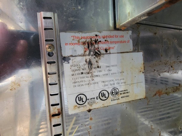 Label inside a mobile kitchen trailer showing equipment specs. Includes electrical rating, refrigerant type, and safety certifications.