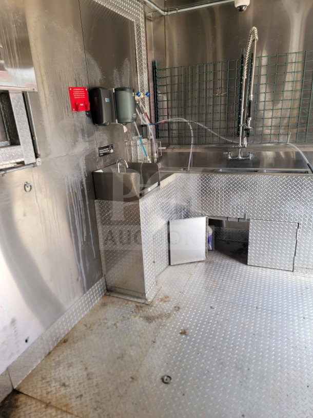 2021 Diamond Cargo 8.5' x 24' mobile kitchen trailer interior, stainless steel surfaces, sink, and diamond plate flooring.