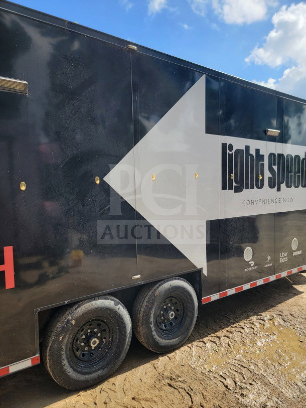 2021 SDG 8.5' x 20' dual-axle mobile kitchen trailer, branded, with durable wheels, in good condition.