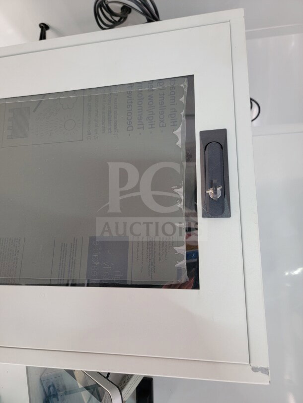 Glass display panel on the 2021 SDG 8.5' x 20' Mobile Kitchen Trailer. Features lock mechanism and visible interior documentation.
