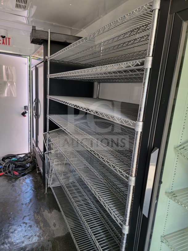 2021 SDG 8.5' x 20' trailer interior with metal shelving, part of a cold-storage setup. True Refrigeration Suite visible.