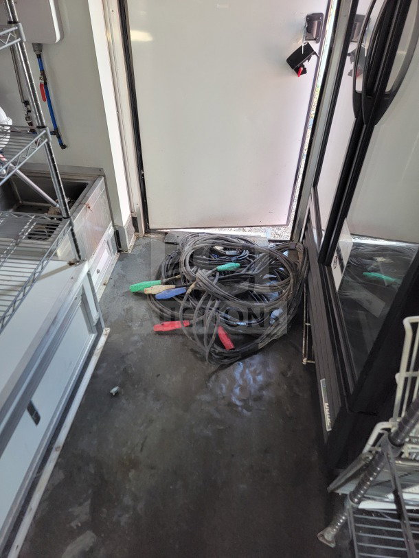 2021 SDG 8.5' x 20' mobile trailer interior, featuring True Refrigeration. Includes coiled cables, shelf units.