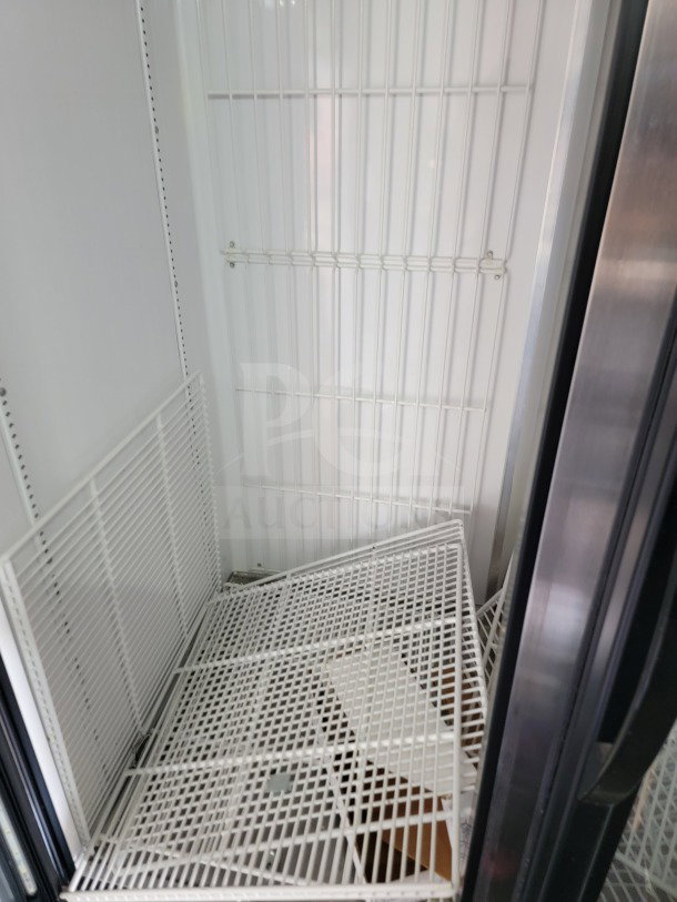 Interior view of a 2021 SDG 8.5' x 20' trailer's refrigeration unit with metal shelving. Clean and well-maintained.