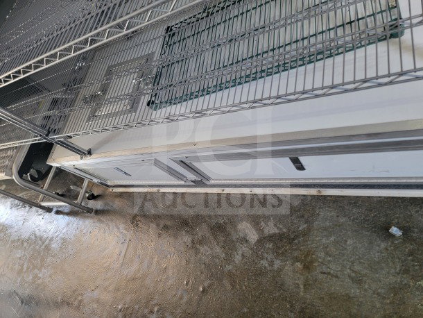 SDG 8.5' x 20' double-axle trailer interior with shelving. Includes True Refrigeration suite. Ideal for cold storage.