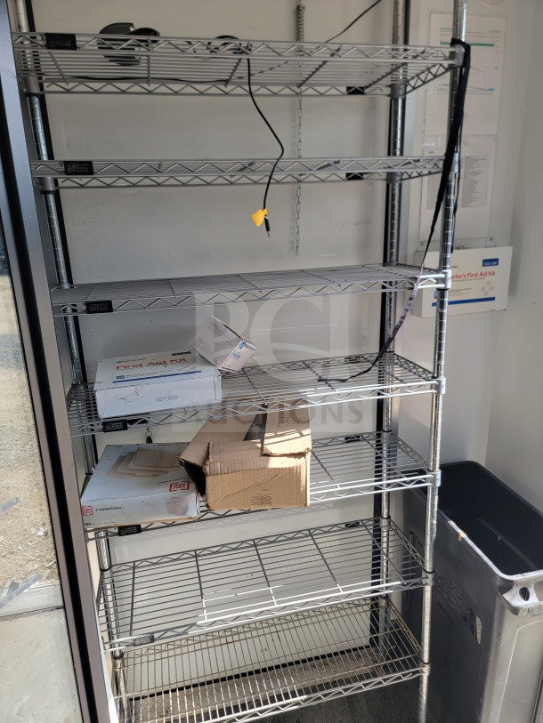 Interior of 2021 SDG 8.5' x 20' trailer's cold-storage with wire shelving, boxes, cables, and a first aid kit visible.