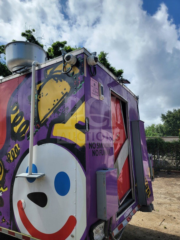 Purple 2021 Rock Solid Cargo 8.5' x 24' mobile kitchen trailer with playful design, security cameras, and "No Smoking" sign.