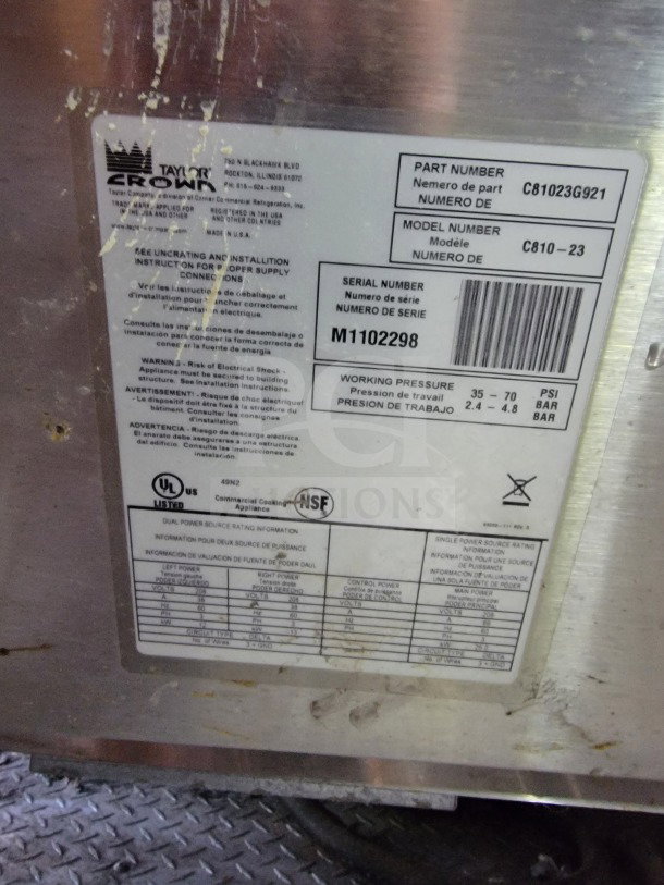 Label on a Rock Solid Cargo mobile kitchen trailer showing model C810-23, serial number M1102298, and power details.