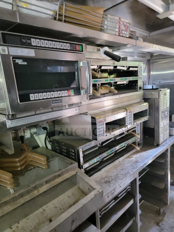 Interior of 2021 Rock Solid Cargo mobile kitchen trailer with cooking appliances. Features CaptiveAire hood, True and Hoshizaki refrigeration systems.