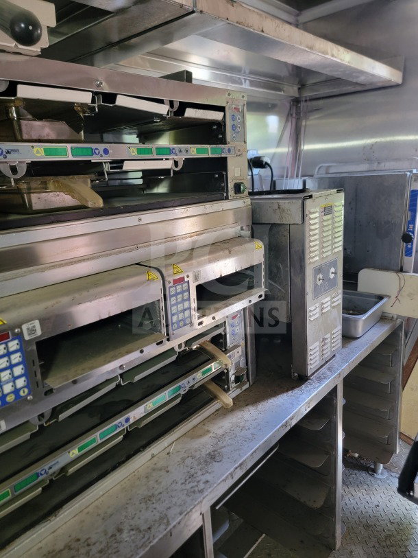 2021 Rock Solid Cargo 8.5' x 24' mobile kitchen trailer interior, showcasing cooking equipment, stainless steel counters, and ventilation.