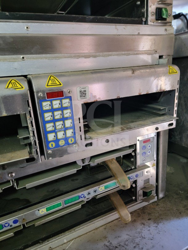 Interior view of a 2021 Rock Solid Cargo mobile kitchen trailer featuring CaptiveAire hood controls and digital displays.
