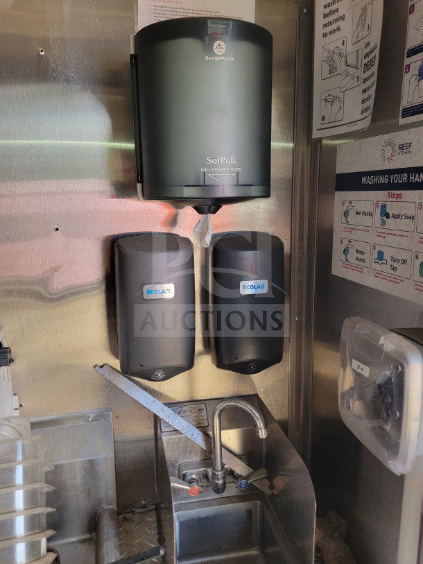 Dual Ecolab dispensers and Georgia-Pacific SofPull paper towel dispenser above a Browne sink in a mobile kitchen.