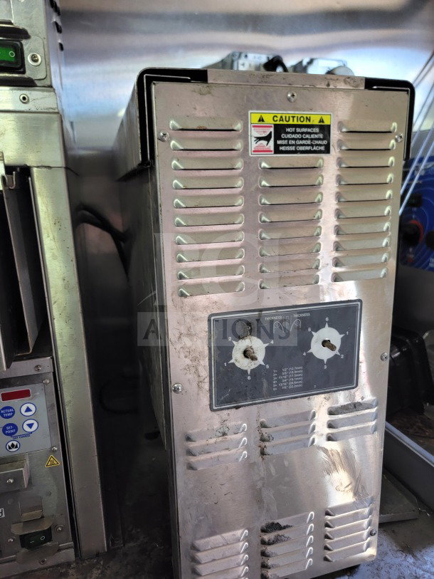 Interior view of a 2021 Rock Solid Cargo mobile kitchen trailer featuring a stainless steel panel with caution label.