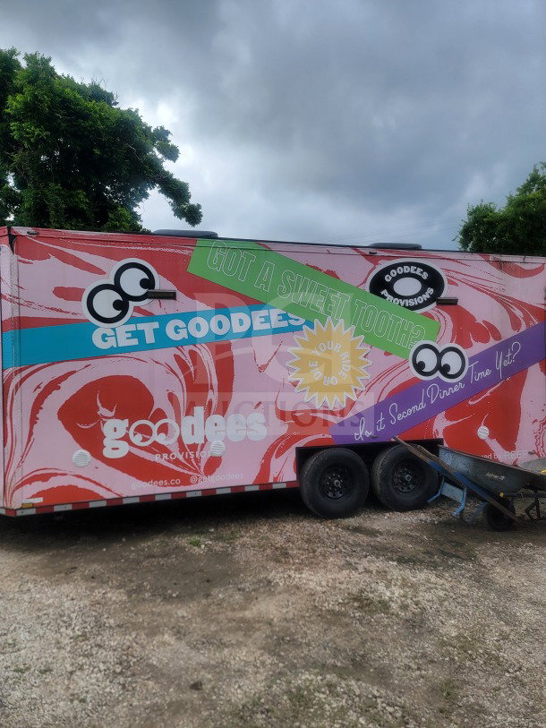 2021 SDG 8.5' x 20' dual-axle trailer with custom cold-chain storage, colorful branding, and glass-door refrigeration.