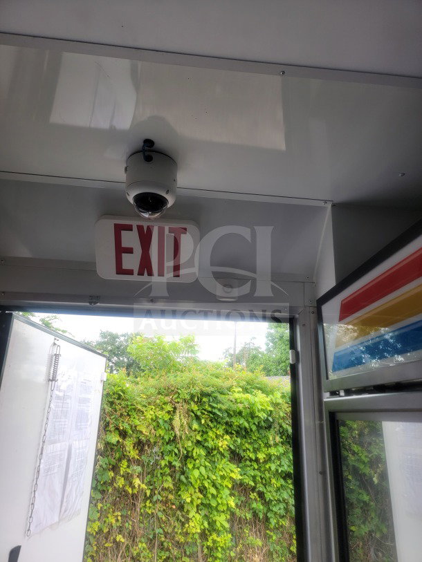Interior view of 2021 SDG 8.5' x 20' trailer with exit sign, security camera, and open door. Features cold-chain storage.