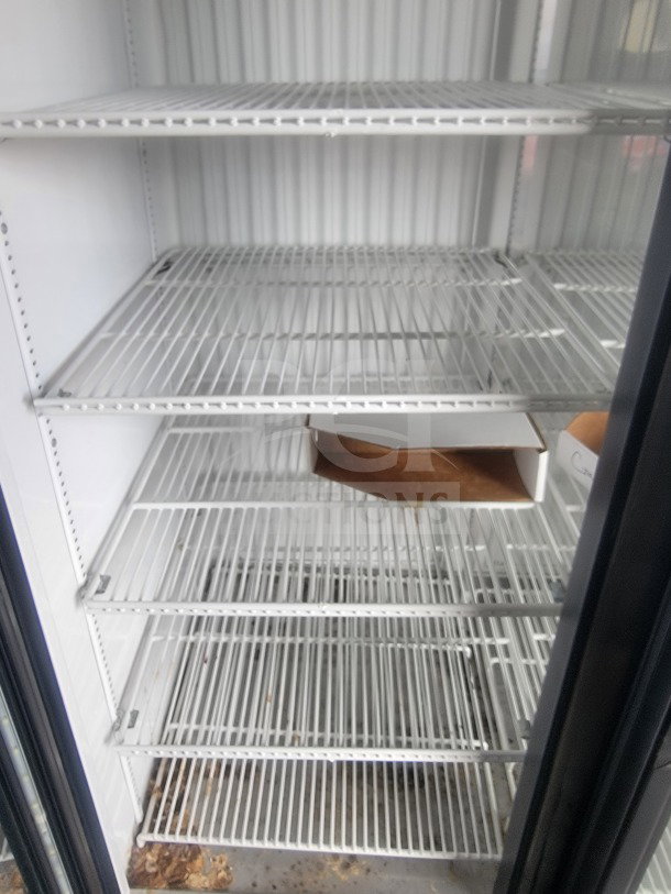 Interior view of True glass-door refrigeration suite with metal shelves in SDG 8.5' x 20' dual-axle trailer.