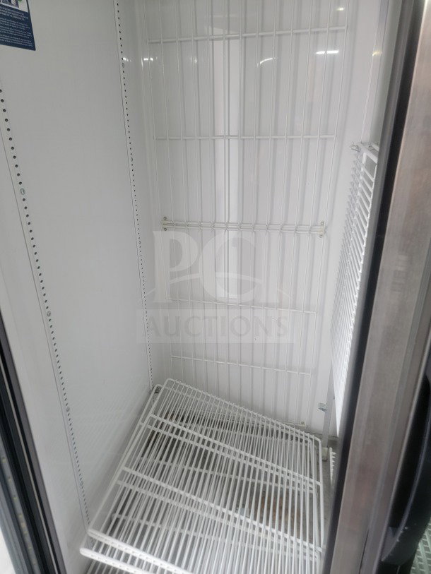 Interior view of True glass-door refrigerator in 2021 SDG dual-axle trailer, showcasing wire shelving.