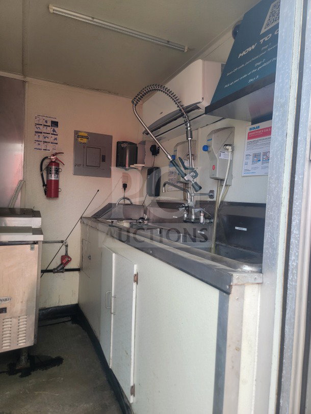 2021 Rock Solid Mobile Ghost Kitchen Trailer interior showing stainless steel sink, Serv-Ware refrigeration, fire extinguisher.